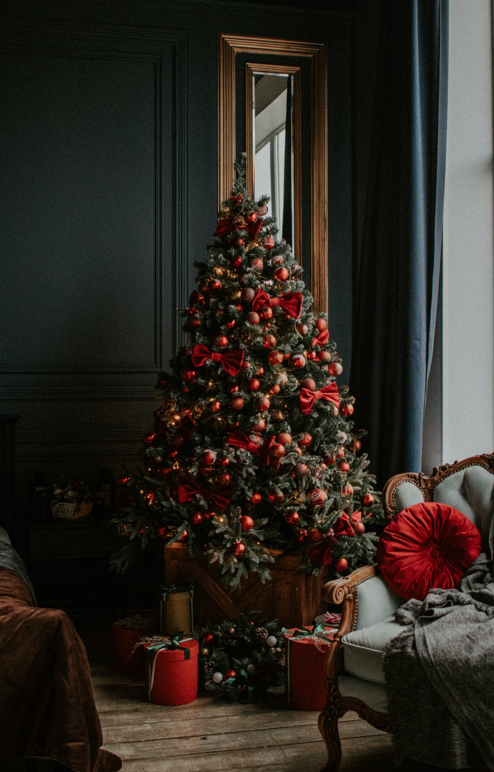 Christmas flowers and gifts. Beautiful living room decorated with Christmas tree, flowers and gifts.